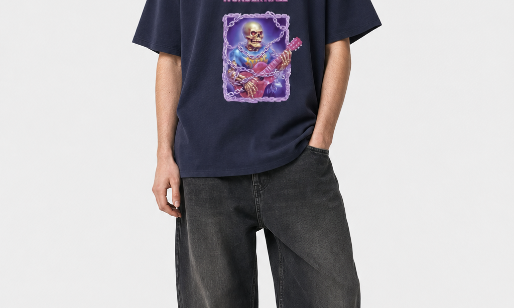 Model wearing the DORTI Caution: Will Play Wonderwall navy tee with baggy jeans, full length