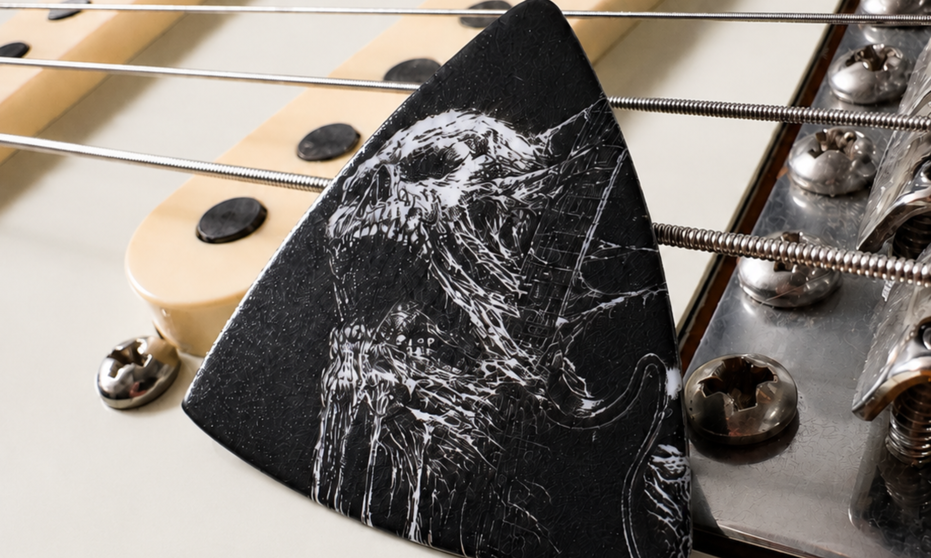 DORTI Shredder guitar pick resting on the bridge of an electric guitar
