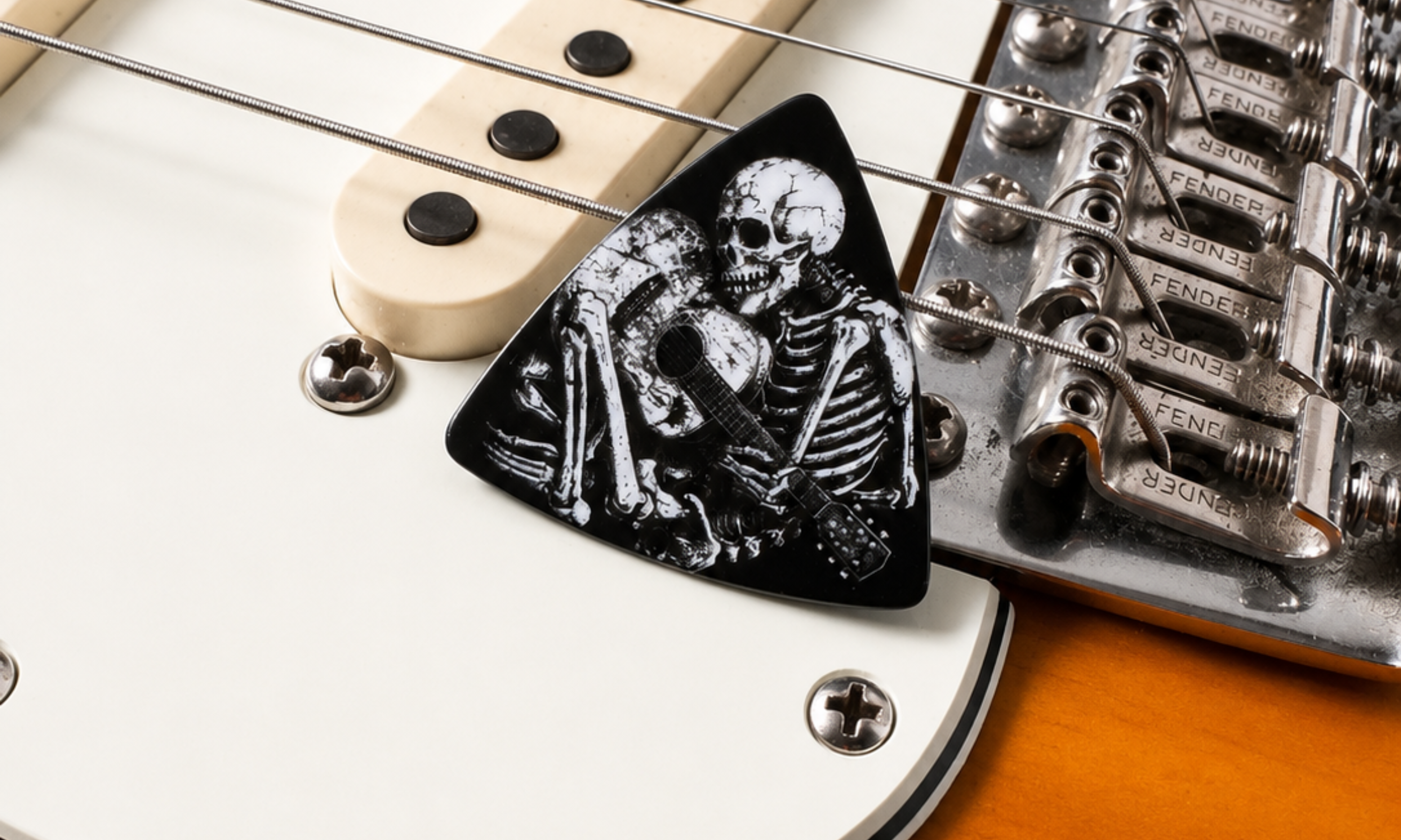 DORTI 'Til Death pick resting by the bridge of a sunburst electric guitar