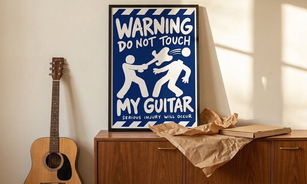 DORTI Don't Touch My Guitar framed poster on a wooden sideboard beside an acoustic guitar