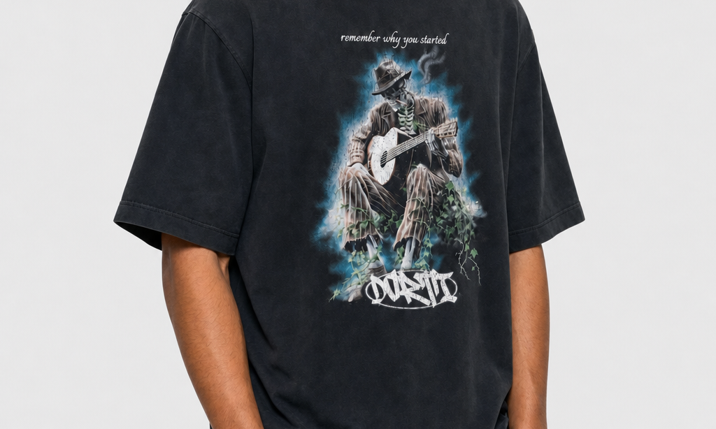Model wearing the DORTI Remember Why You Started acid-wash tee with grey jeans