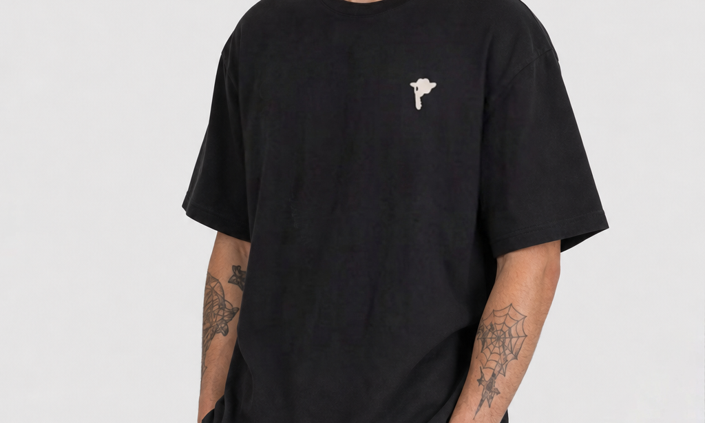 Model wearing the DORTI Broken Strings Broken Hearts black tee, front view