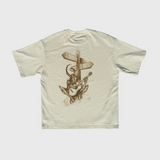 Beige DORTI t-shirt with a graphic design on the back featuring a person playing a guitar and two directional signs.