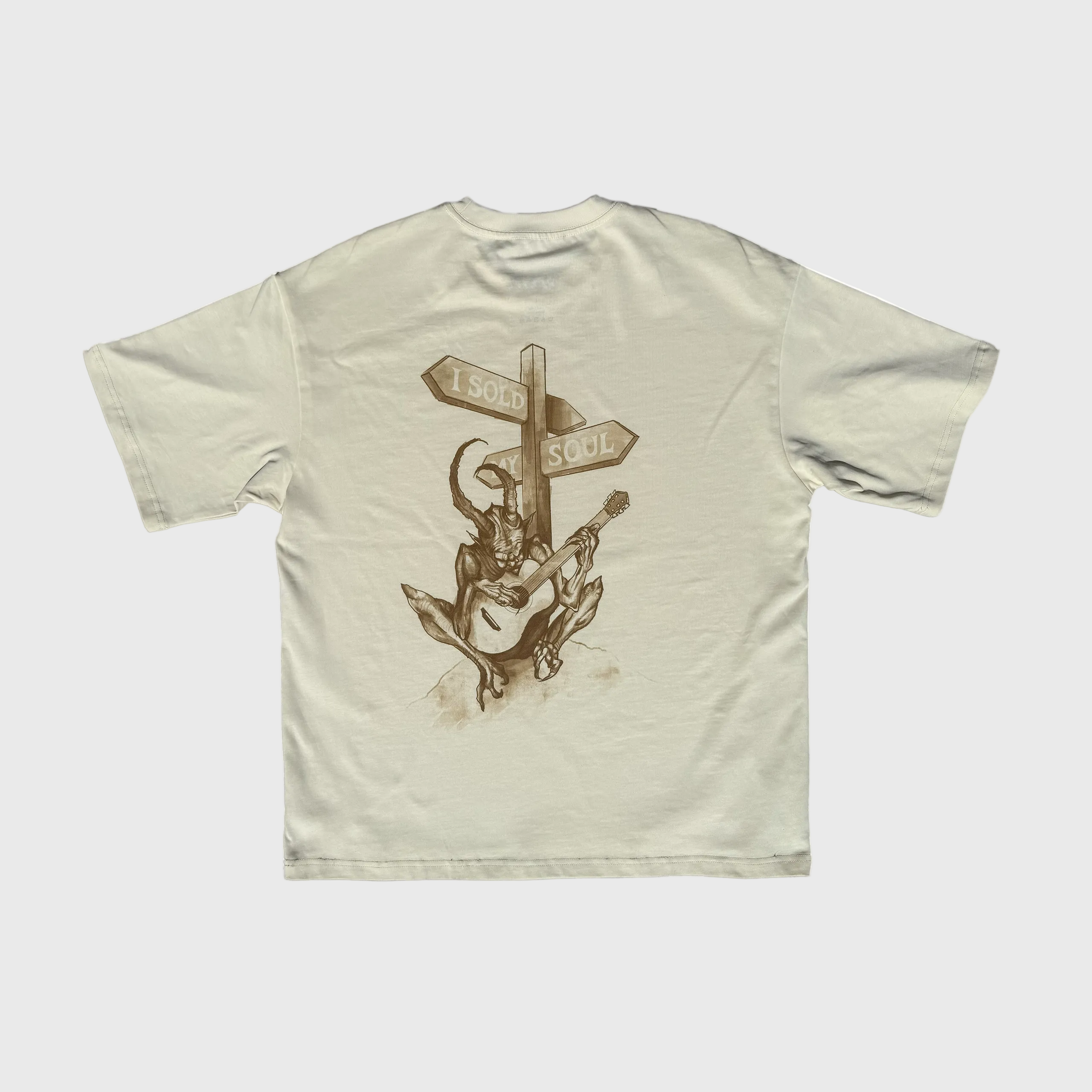 Beige DORTI t-shirt with a graphic design on the back featuring a person playing a guitar and two directional signs.