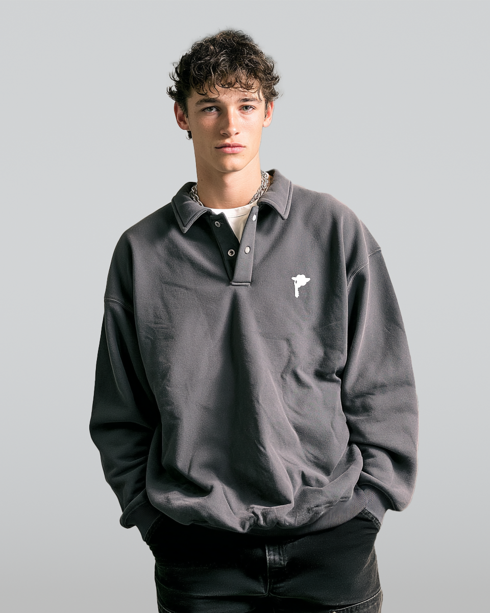 Man wearing a gray DORTI sweater with a small Jimi Skull logo on a plain background