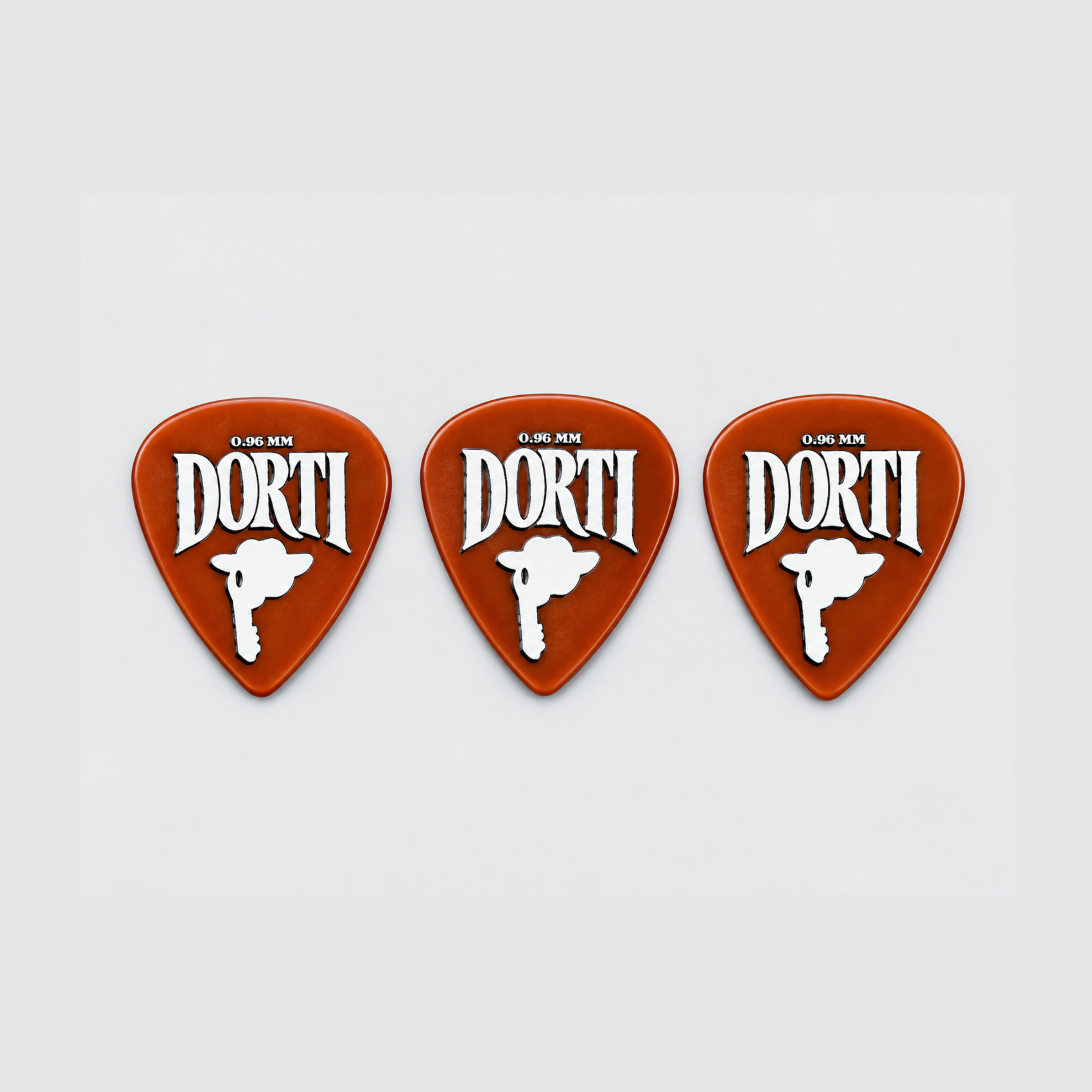 Three DORTI Standards orange nylon guitar picks in a row