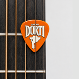DORTI orange nylon guitar pick resting on the strings over a guitar fretboard