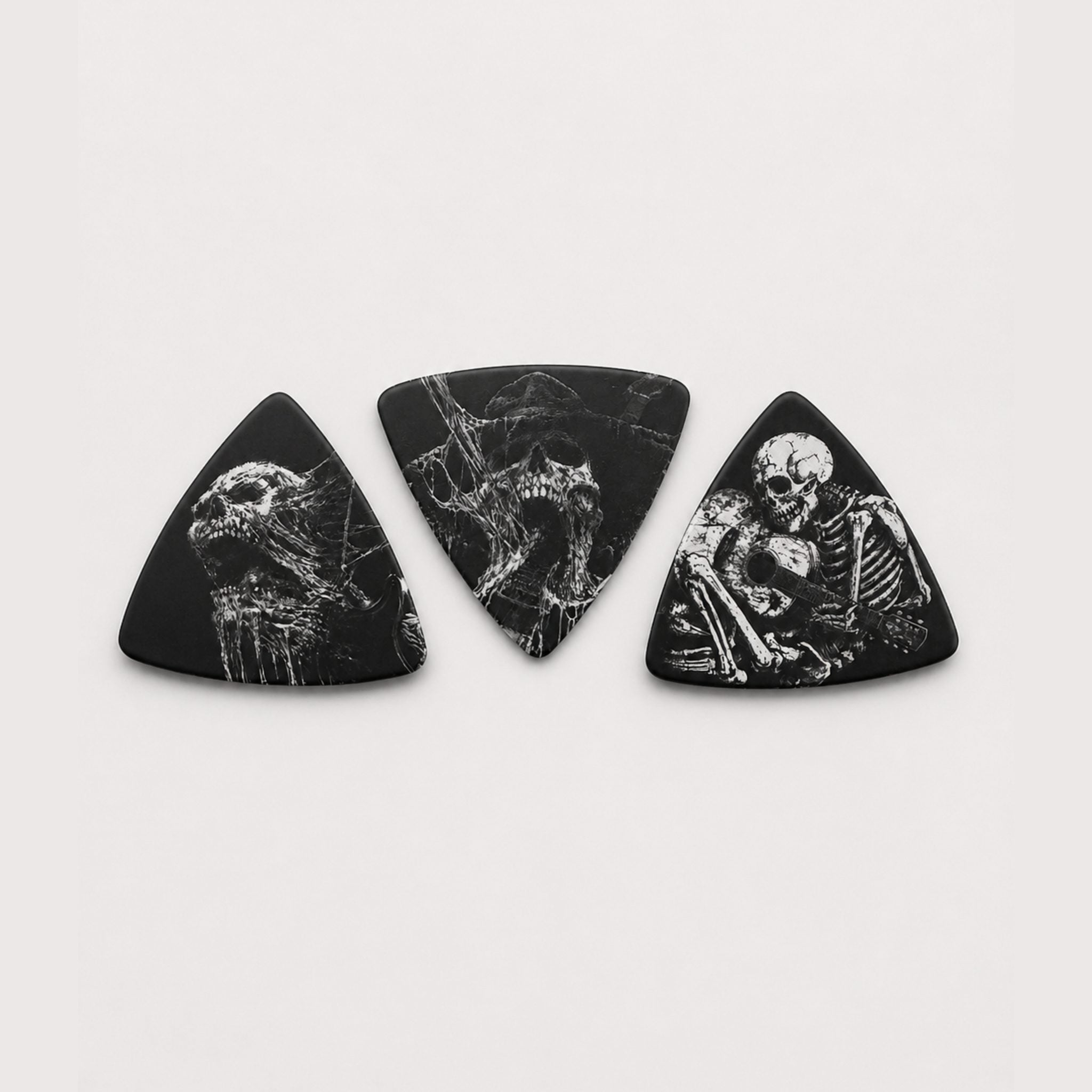 DORTI Boneyard Collection variety pack: three black triangle Delrin guitar picks with skeleton art