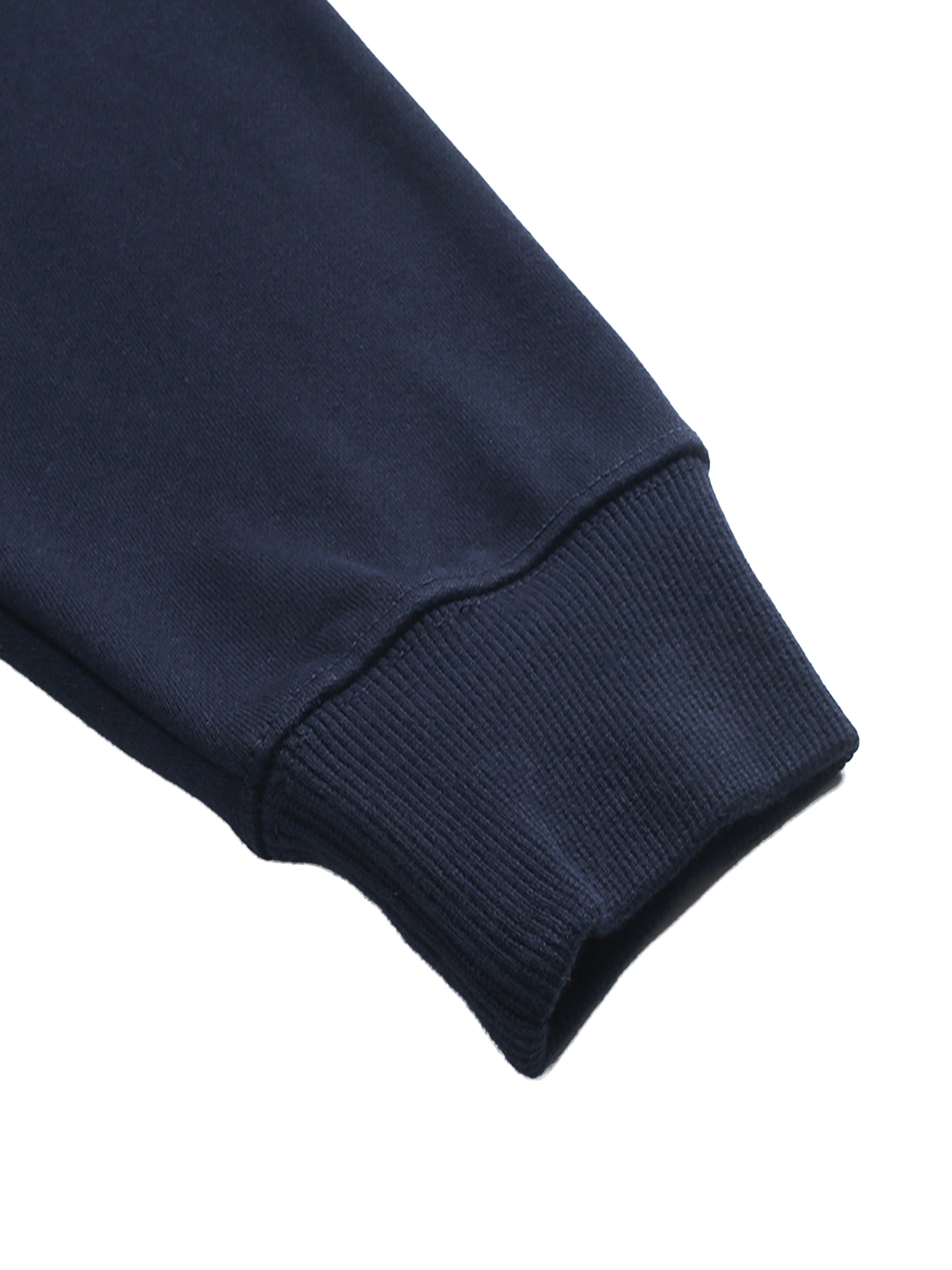 Close-up of a navy blue DORTI sweater sleeve on a white background