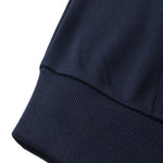 Close-up of a navy blue DORTI fabric edge on a white background