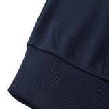 Close-up of a navy blue DORTI fabric edge on a white background