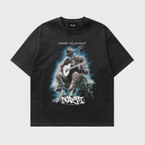 Black t-shirt with a graphic of a person playing guitar and text on a white background