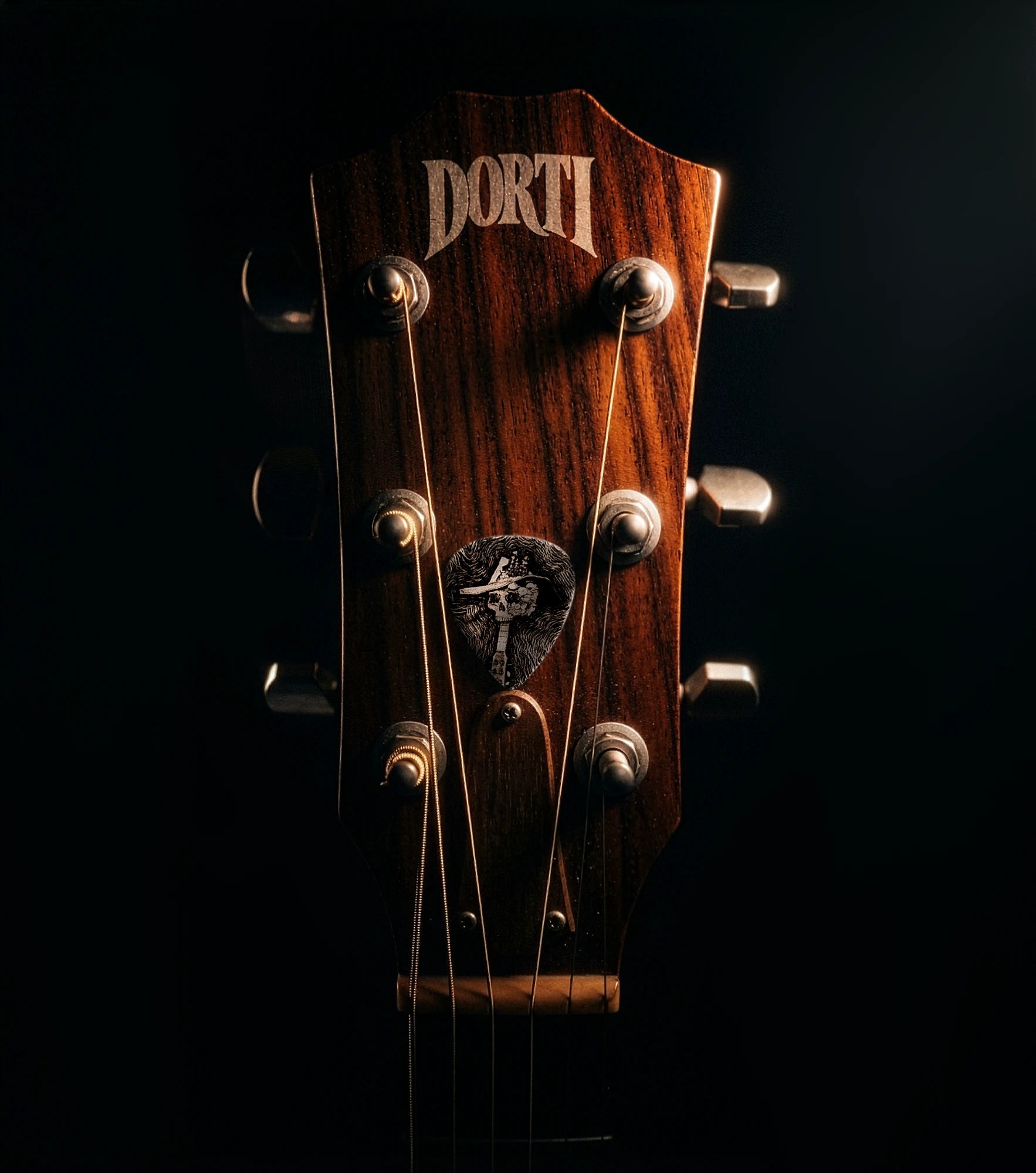 DORTI guitar headstock with a Jimi Skull pick tucked in the strings